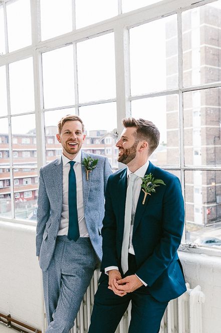 Gay wedding with grooms in different toned blue suits