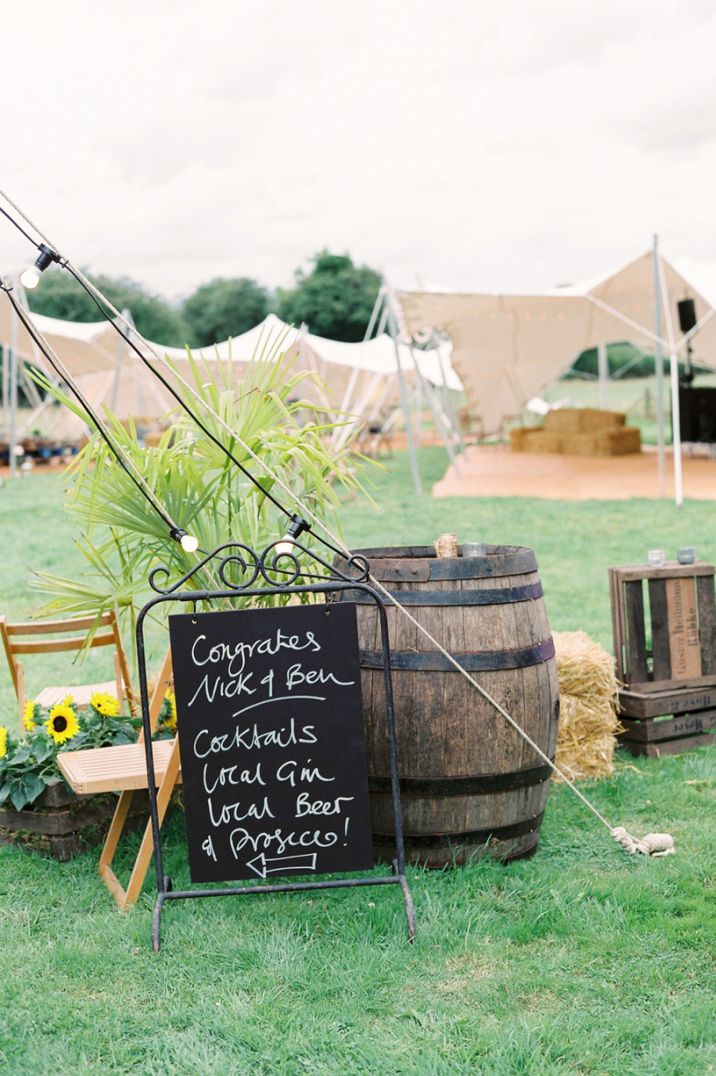 Wooden barrel and chalkboard wedding sign for festival wedding