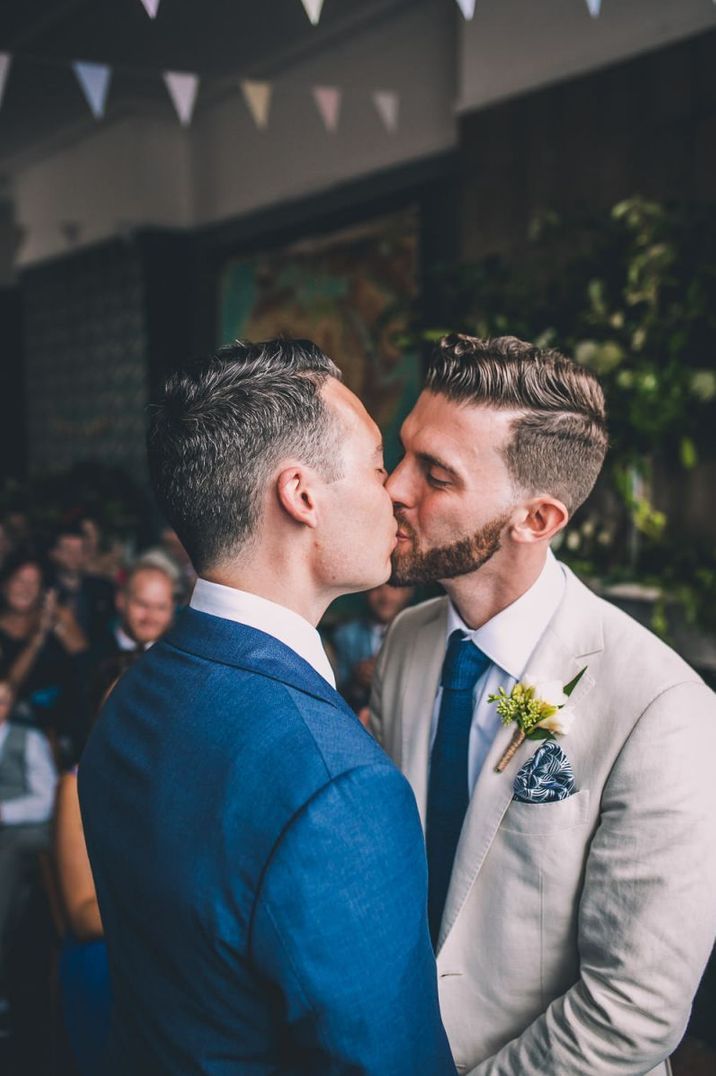 Gay wedding with Grooms in blue and beige blazers