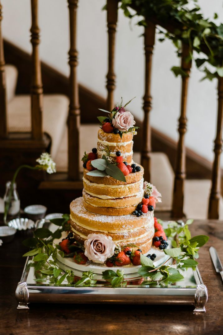 Three tier naked wedding cake with floral decor 