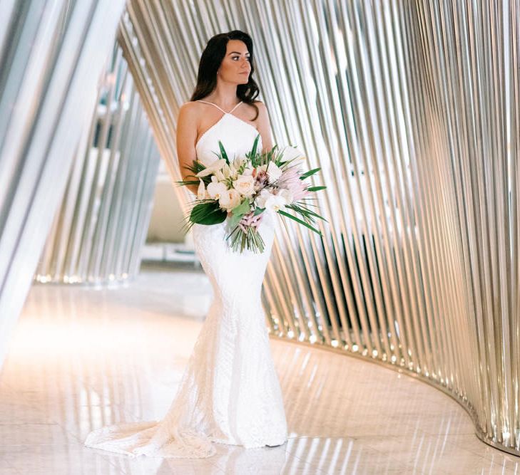 Striking bride wearing Vagbond Bridal with King Protrea Wedding Bouquet 