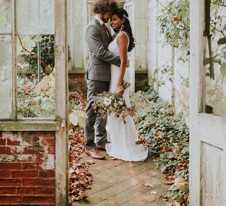 Bride and groom portrait in the greenhouse at Hooton Pagnell Hall