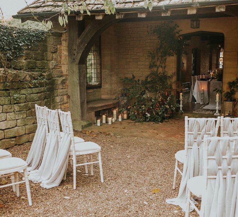 Outdoor wedding ceremony at Hooton Pagnell Hall with fabric chair back decoration