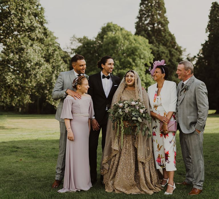 Family portraits at multicultural wedding 