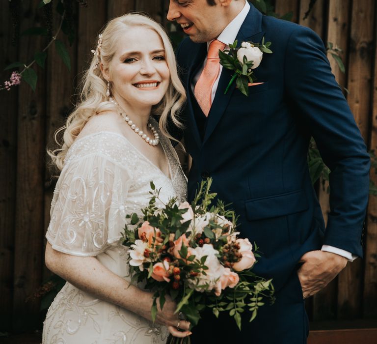 Bride & groom pose together after wedding ceremony