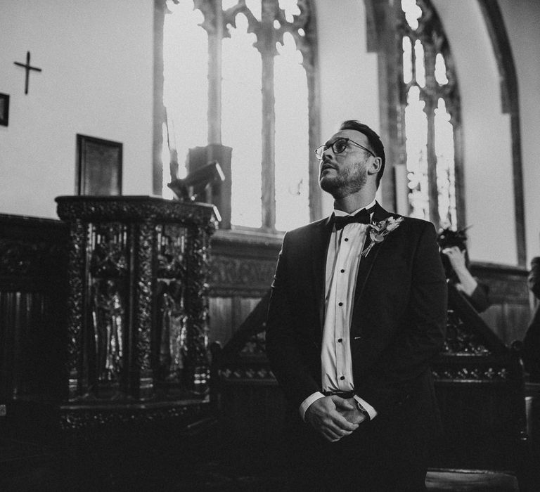 Groom waits for bride in black tie 