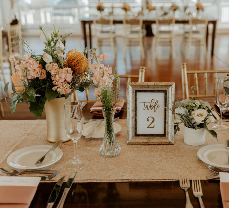 Blush pink and peach wedding flowers and gold table runner wedding reception decor 