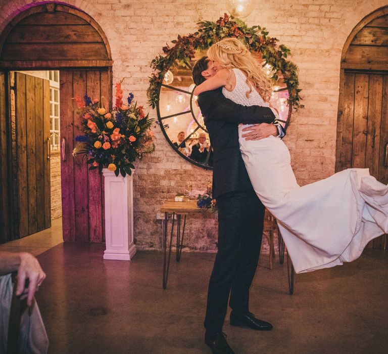 Groom swings bride in Justin Alexander wedding dress in first dance at Iscoyd Park wedding reception