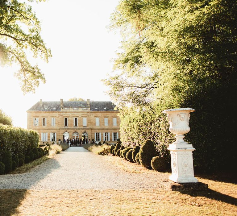 Long driveway leading up to a French chateau