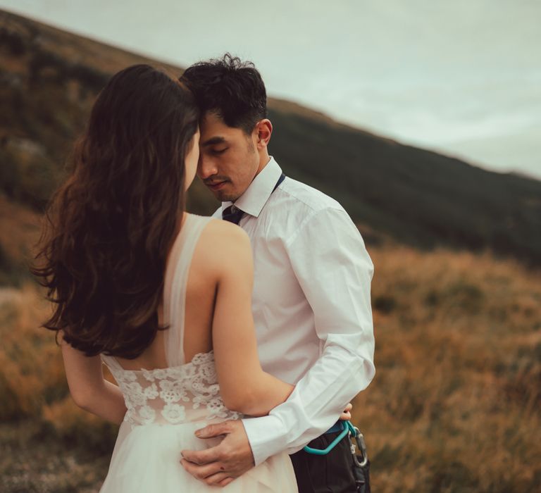 Couple embrace during engagement session in Scotland