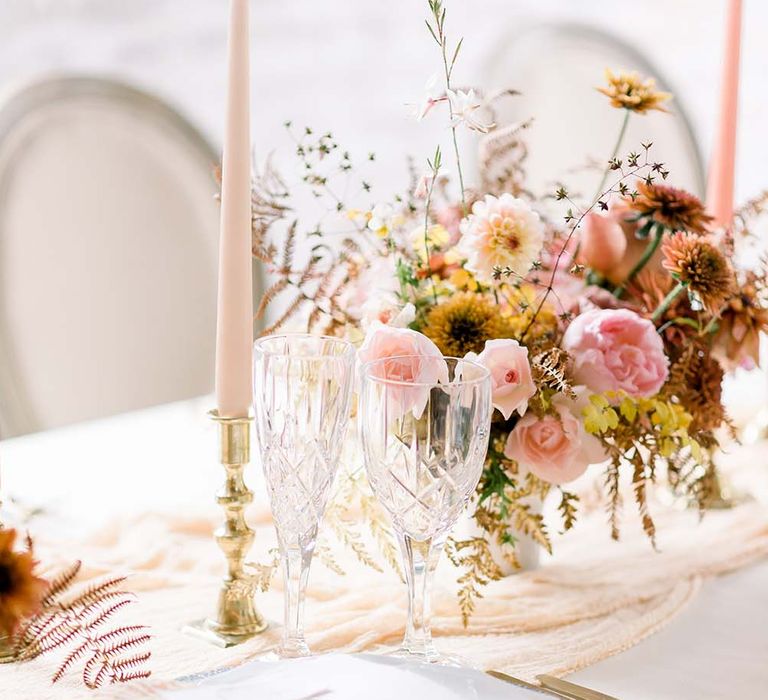 Gold candlesticks, pink taper candles, cut glass and autumn flower arrangements for Dorfold Hall reception decor