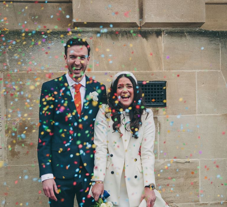 Bride and groom confetti moment bride wears alex perry wedding dress