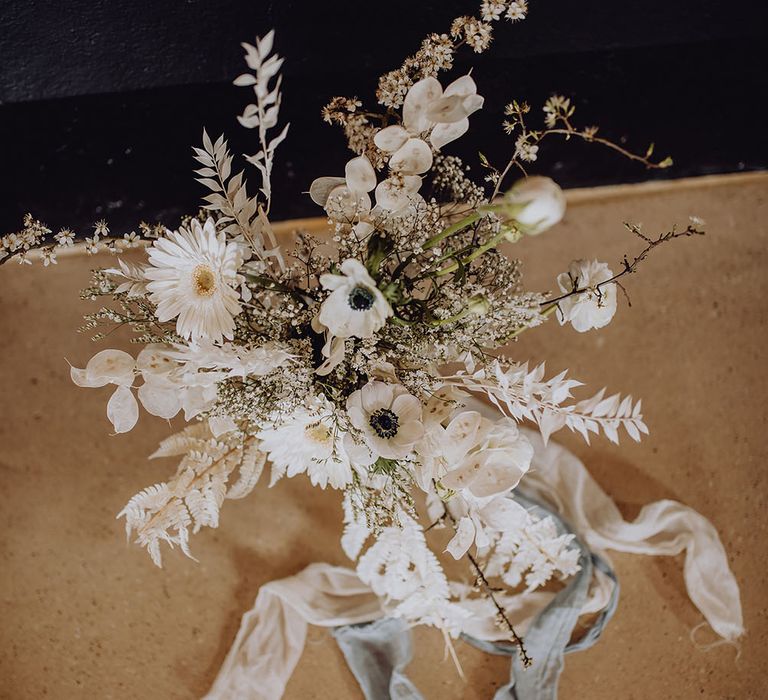 White floral arrangement with gerberas and fern leaves