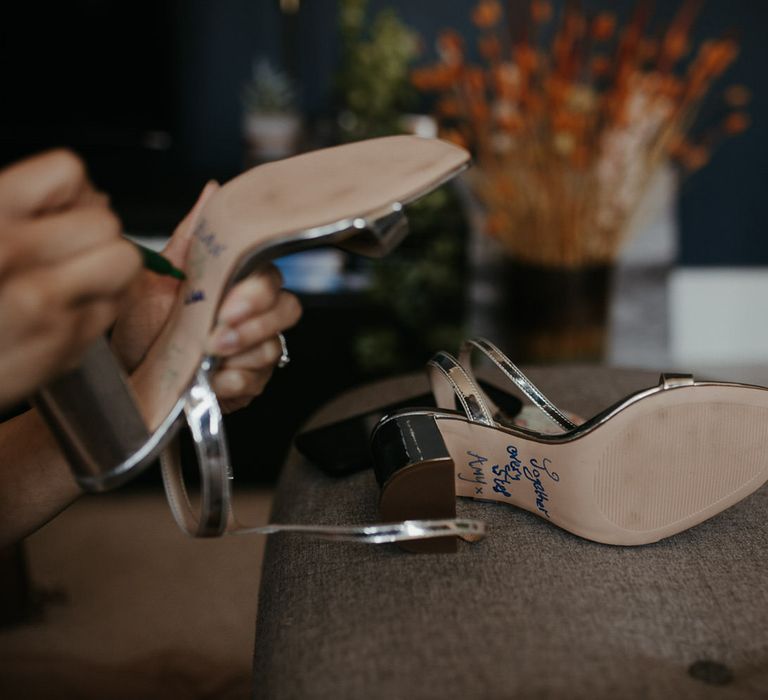 Blue writing on the bottom of the bridesmaid shoes reading 'together every step'