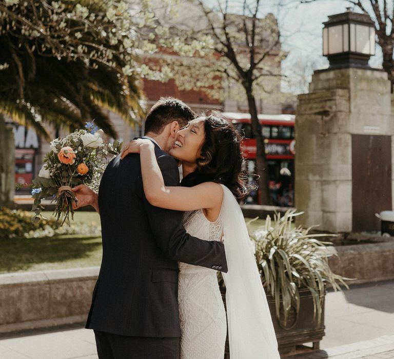 Bride and groom hug after first look at Hackney Town Hall