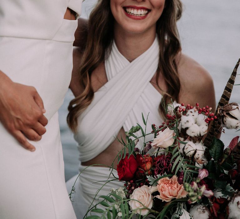 Goddess style bridal outfit with floral headpiece, adjustable gown and long wavy curls