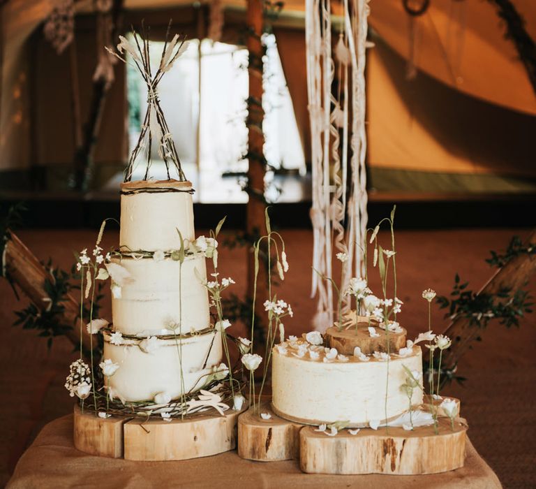 Rustic wedding cake on tree slices with cake tipi cake topper for boho wedding 