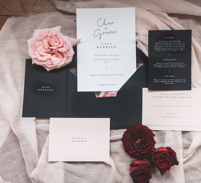 Contemporary black and white wedding stationery suite with floral envelope insert