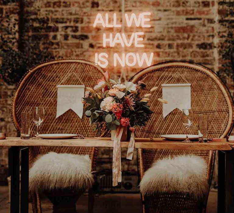 Neon wedding sign and peacock chairs for bride and groom