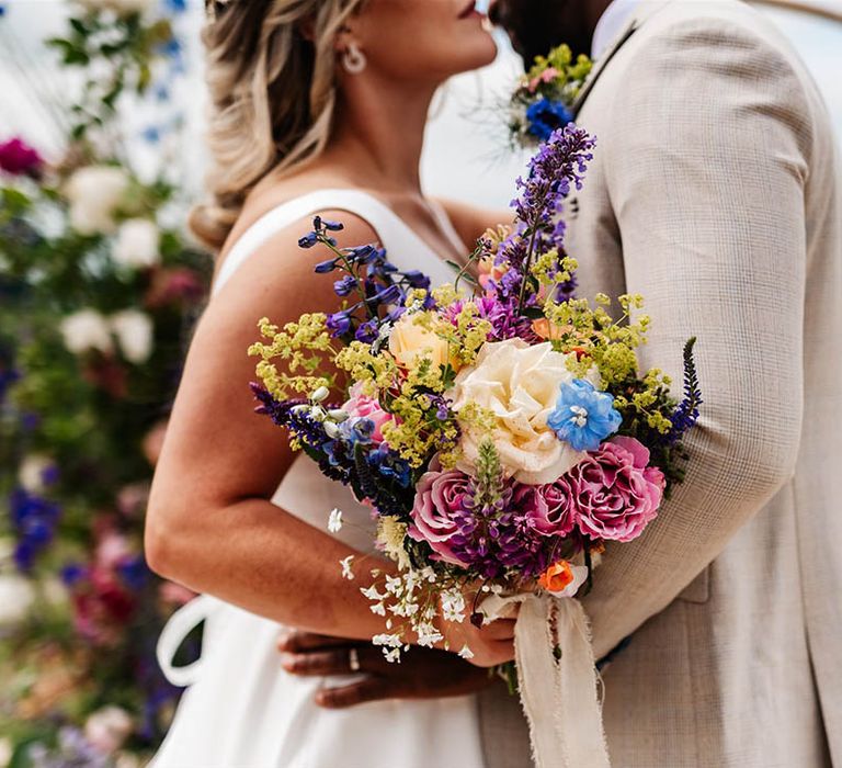 colourful wedding bouquet with roses, bluebells and stocks 