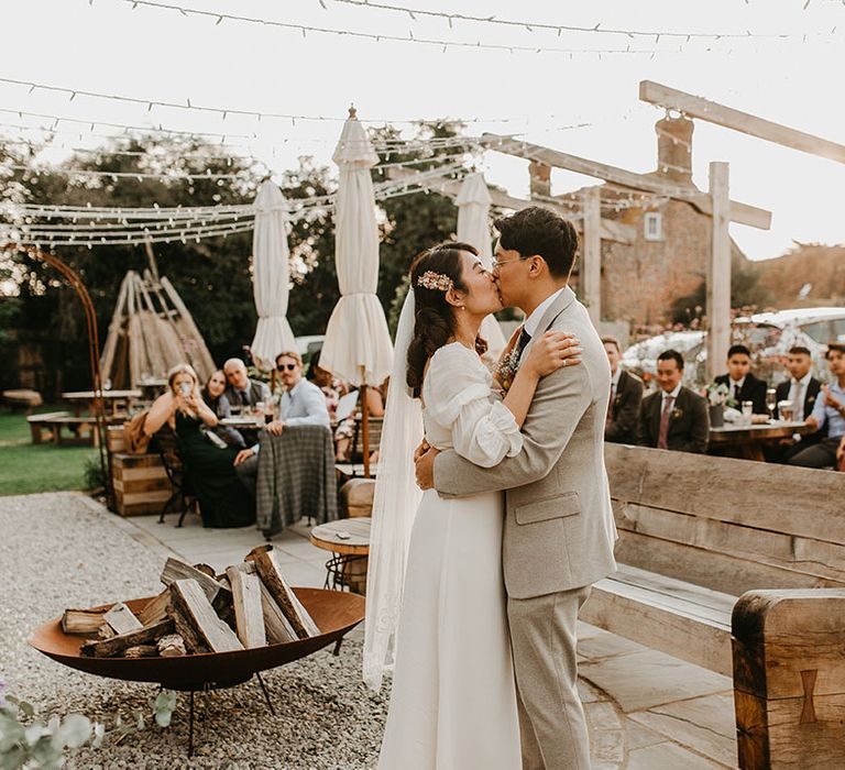 Bride & groom embrace outdoors on their wedding day