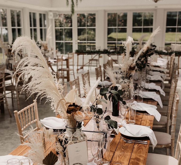 Wooden table finished with rustic vibe and dried florals