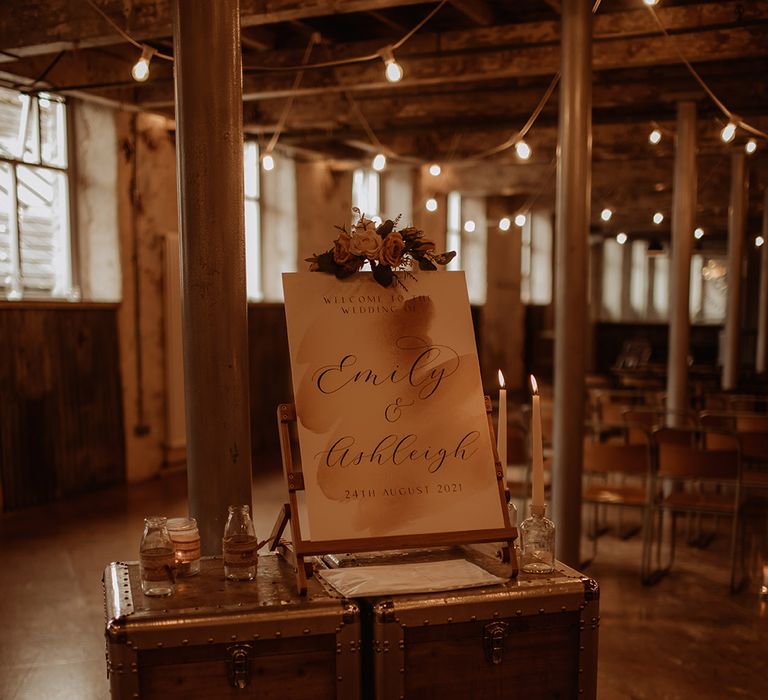 Antique cases with welcome sign complete with mason jars and candles 