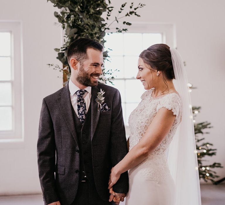 Bride & groom look lovingly at one another on their wedding day