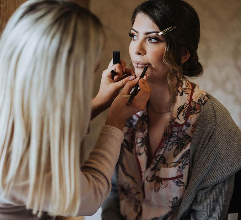 Bride gets her makeup done for November wedding 