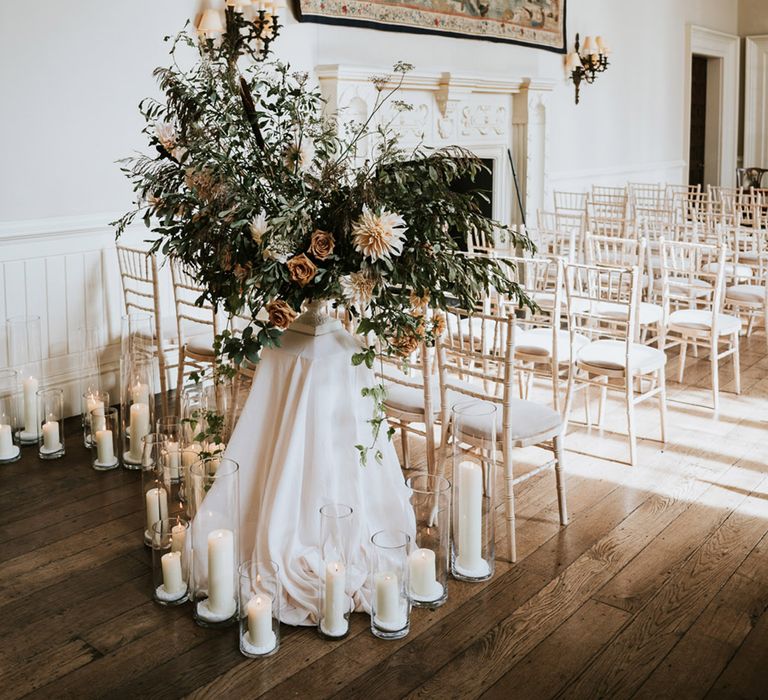 Wedding ceremony flowers and decor with dahlias, foliage and candles 