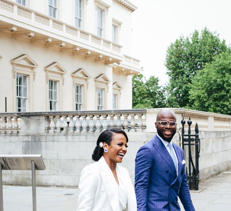 Bride & groom walk through London after wedding ceremony