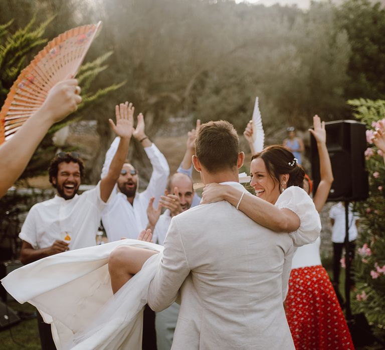 Groom lifting the bride as they dance