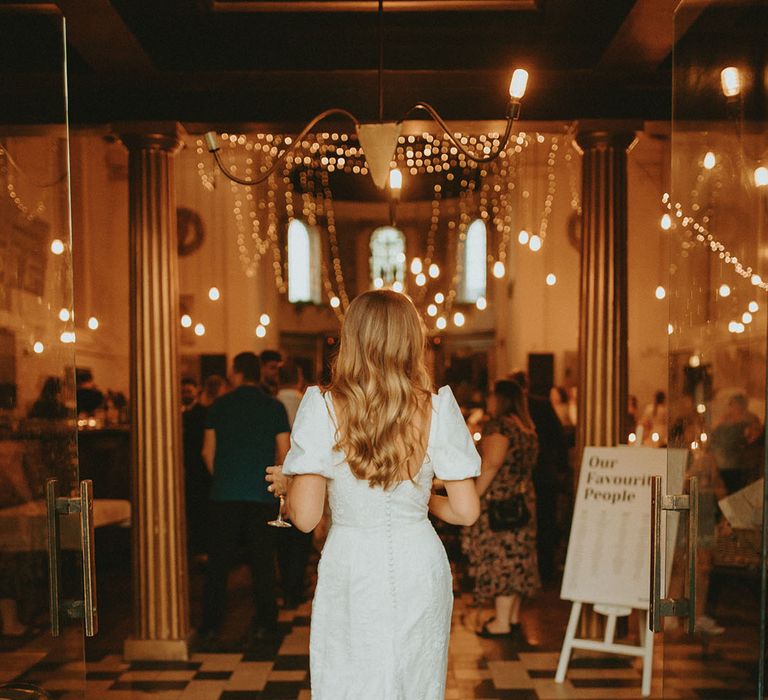 Bride's patterned and textured wedding dress with button detail and puff sleeves from Story of My Dress 