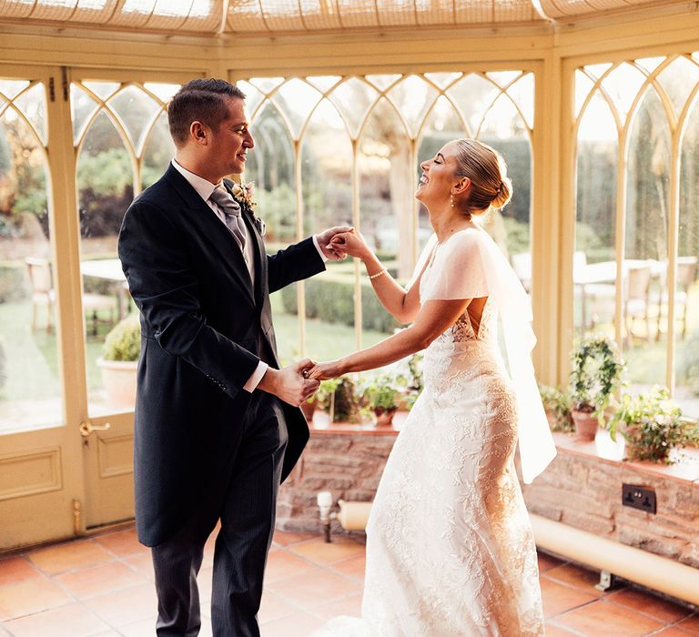 Bride and groom share a dance in a conservatory at Dewsall Court 