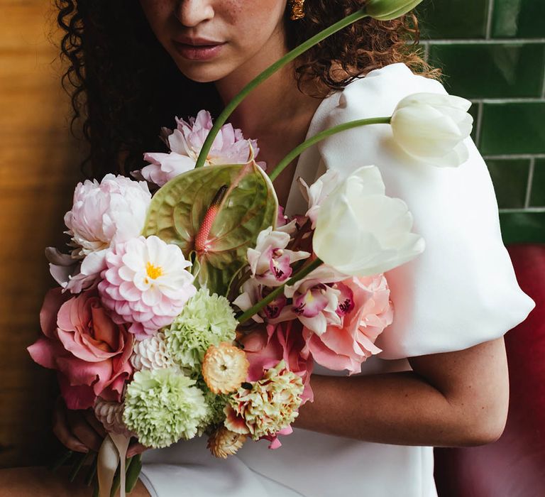 Zesty green and pink wedding bouquet with carnations, anthuriums, roses, dahlias and tulips