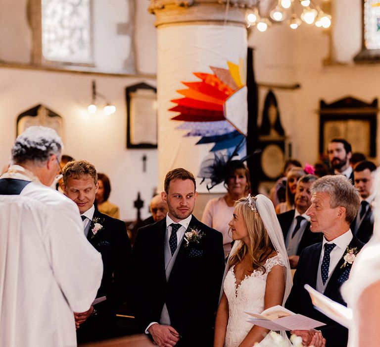 Bride and groom glance at each other during their church wedding ceremony 