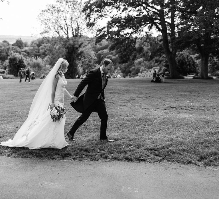 Bride walks with the groom around Bristol on their wedding day 