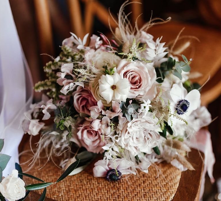 Pink and white wedding bouquet with foliage for the bride 