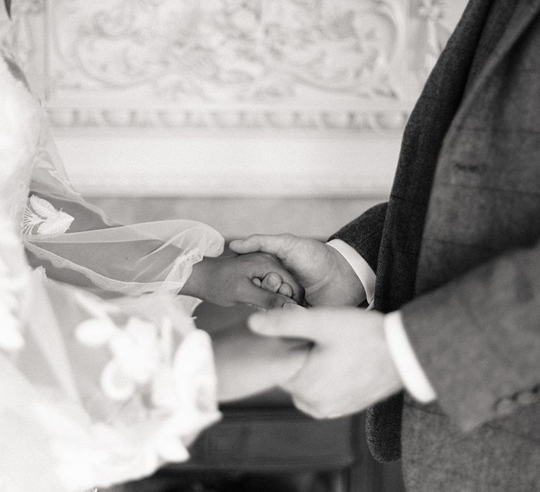 Bride and groom hold hands for their wedding ceremony at the Bedford Swan Hotel 