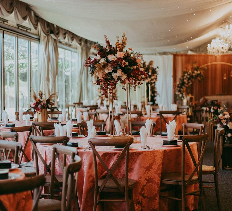 Autumnal coloured floral installation centrepieces for boho chic tablescapes with colourful tablecloths 