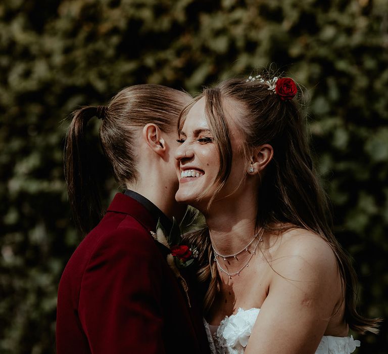 Brides share an intimate embrace together at their rustic barn wedding 