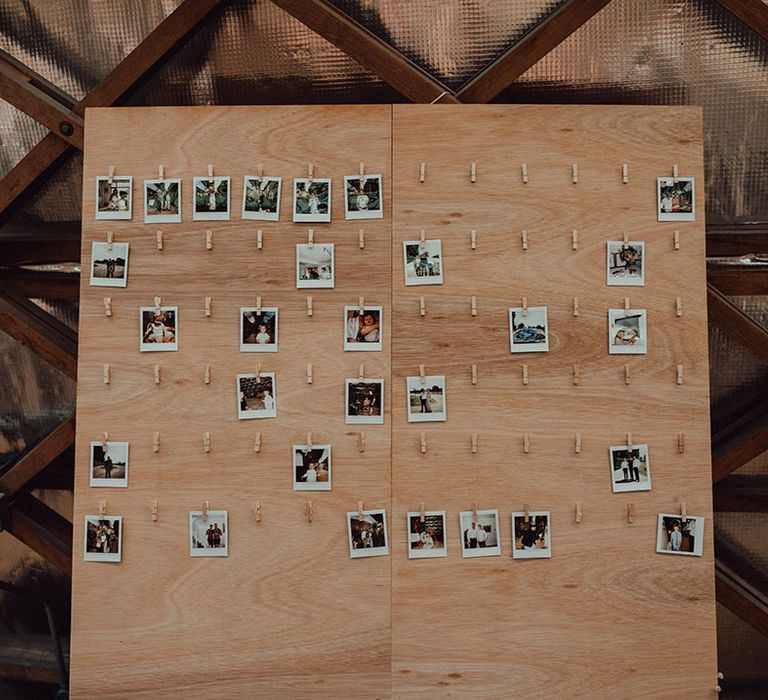 Wooden peg board for the guest to peg their polaroid pictures of the wedding guests 