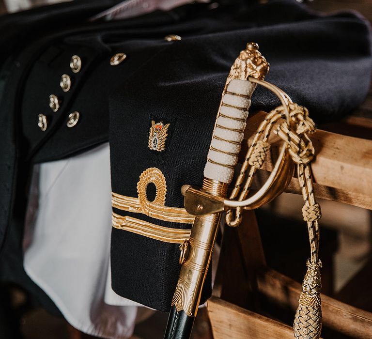 Groom's military uniform for the wedding with the sword and white hat