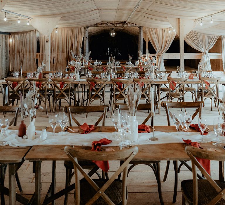 Unique wedding venue Rhyse Farm in Worcestershire with a white and burnt orange wedding tablescpae and bunny grass floral arrangements and disco balls 