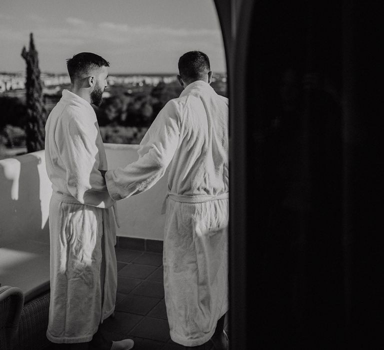 Groom wedding morning preparations in matching white dressing robes