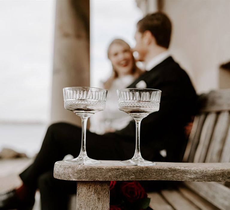 Pretty detailed champagne coupe glasses for the bride and groom on their wedding day 