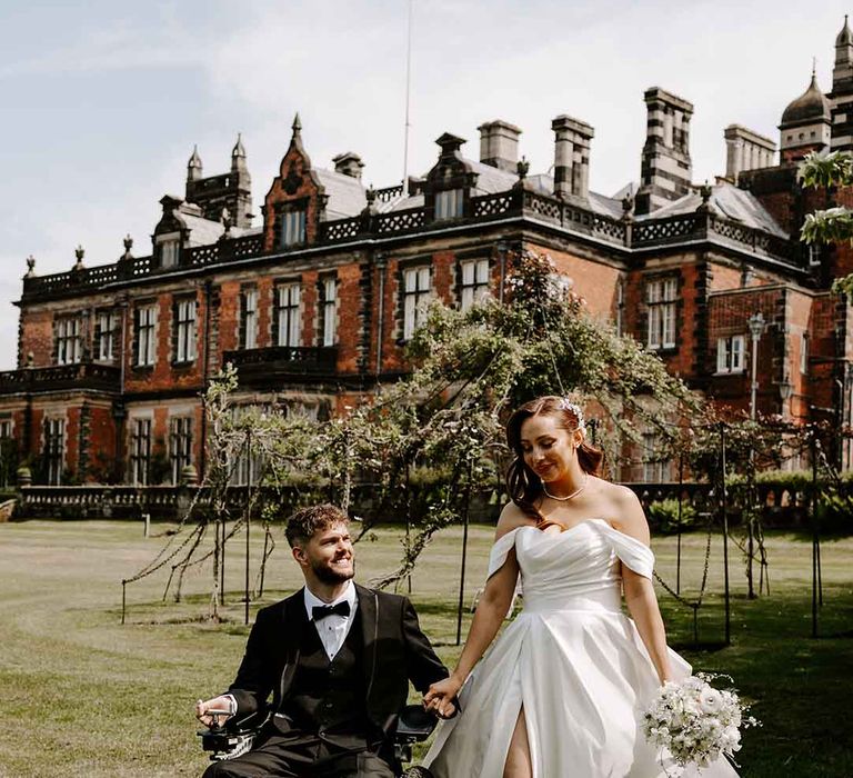 Interbred couple at country house wedding with tuxedo and princess wedding dress