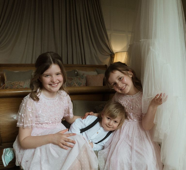 Flower girls in pretty pink Needle & Thread flower girl dresses with little page boy 