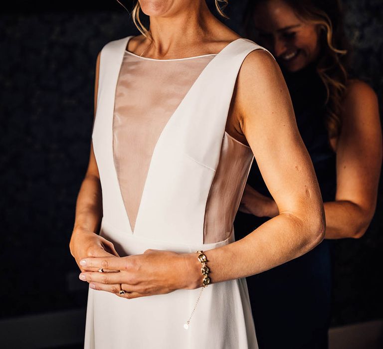 Bride with blonde hair in a braid crown hairstyle in an Andrea Hawke gown 