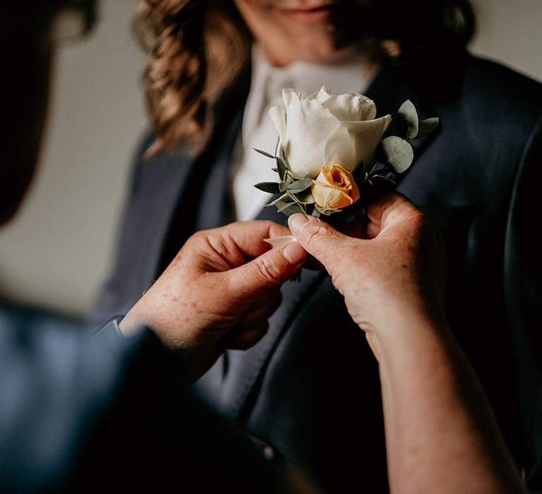 white and orange rose boutonniere 